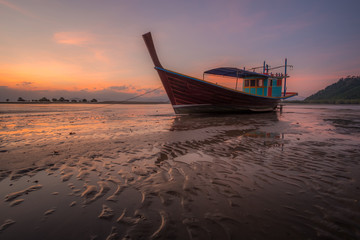 boat on beach at sunset