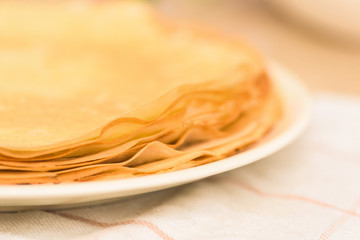 Maslenitsa is a national holiday at the end of February . pancakes are fried for a week with honey on a light background. blini . space for text