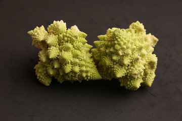 two pieces of romanesco vegetable in color background