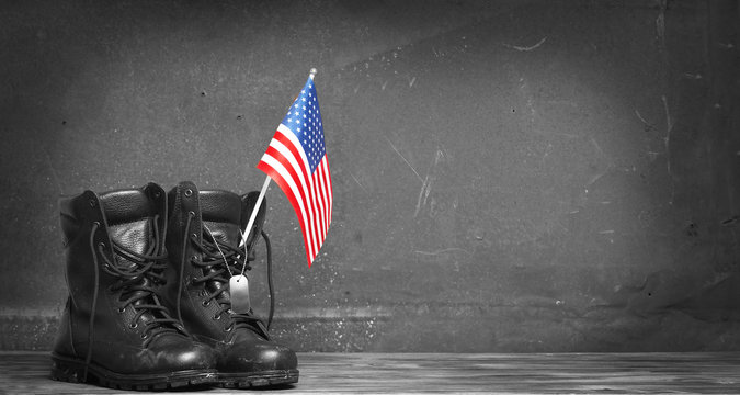 Military combat boots with the American flag and dog tags. Concept - patriotism, protection, remember ,honor ,never forget, thank you