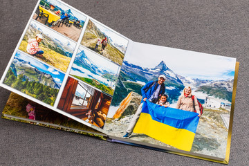 the photobook opened, travel in switzerland, on gray background