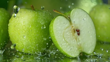 Super Slow Motion Shot of Water Splashing on Fresh Cutted Green Apple at 1000fps. - Powered by Adobe