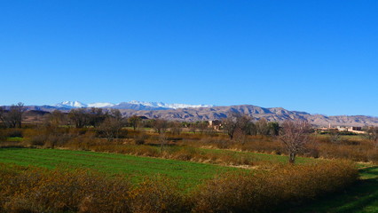 Bright landscape of Morocco, breathtaking curves of mountains, stunning combination of hills & farm land,inadvertent distribution of houses & huts, raw impression of pure nature.