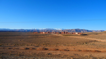Bright landscape of Morocco, breathtaking curves of mountains, stunning combination of hills & farm land,inadvertent distribution of houses & huts, raw impression of pure nature.