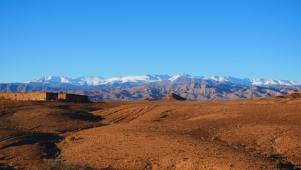 Bright landscape of Morocco, breathtaking curves of mountains, stunning combination of hills & farm land,inadvertent distribution of houses & huts, raw impression of pure nature.