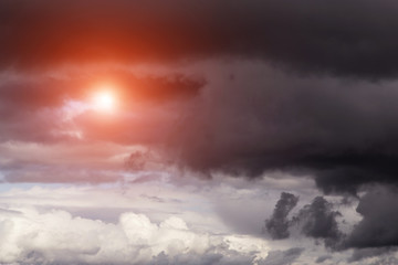 Epic dramatic storm dark grey clouds with sun and sunlight	