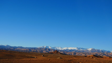 Bright landscape of Morocco, breathtaking curves of mountains, stunning combination of hills & farm land,inadvertent distribution of houses & huts, raw impression of pure nature.
