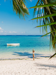 Fototapeta na wymiar Young woman in bikini relax at tropical palm beach. Tropical vacation