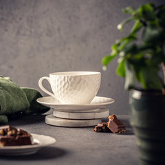 Coffee break composition with cup of coffee and chocolate. Healthy breakfast concept with copy space. Toned photo