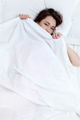 Rest relax recovery sleep dream concept. Young exhausted lady relaxing sleeping dreaming in bed.