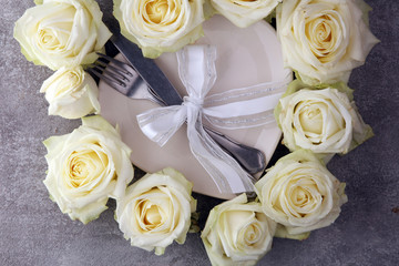 White rose on white dish. Meal on Valentines Day for the woman you love