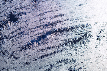 Texture pattern of snowflakes of crystals of snow on glass. Selective Focus. Winter textures, backgrounds patterns. Copy space