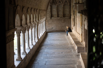 Praying in the gallery of the monastery. France.