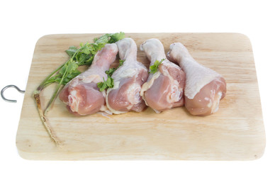 Raw chicken  on cutting board on white background