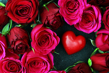 Fototapeta na wymiar Red roses with hearts on background for valentines day concept