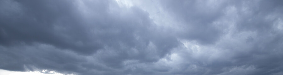 Dramatic overcast sky gloomy dark rain clouds before storm wide angle view