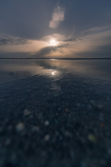sunset with rays breaking through the clouds on proud in Canet-en-Roussillon