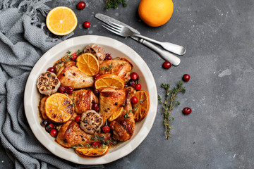 Baked chicken legs with garlic, orange and cranberry. Spicy bbq chicken legs