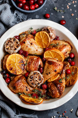 Baked chicken legs with garlic, orange and cranberry. Spicy bbq chicken legs