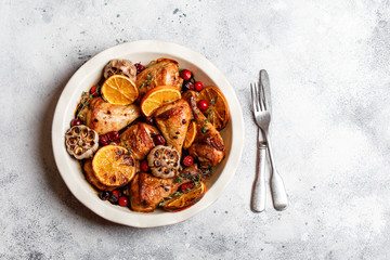 Baked chicken legs with garlic, orange and cranberry. Spicy bbq chicken legs