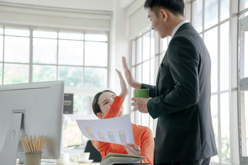 Happy asian business team working together in office