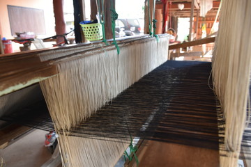 Local loom with fabric pattern on it.