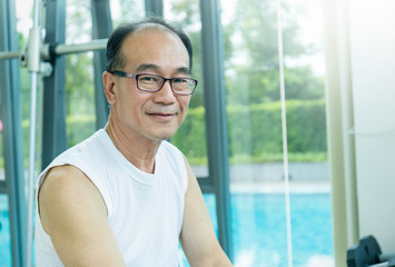Portrait of healthy happy smile senior elderly asian old man face exercise in sport club. Golden...