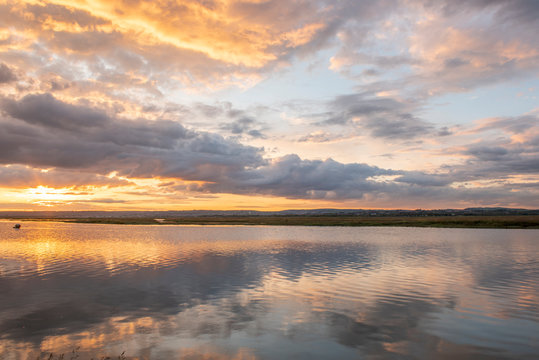 Landscape image of reflections at sunset at Penclawdd estuary