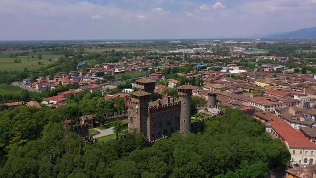 Flying over the Parish of Santa Maria Assunta, Bonoris Castle, Montichiari, Italy. Blue sky. Aerial view