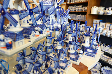 Delft, the netherlands, august 2019. At a shop of the famous white and blue ceramics of miniature windmills to buy as a souvenir.