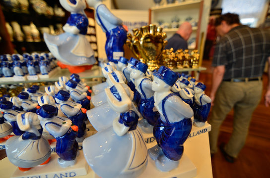 Delft, the netherlands, august 2019. The couple kissing at a shop of the famous white and blue ceramics: a very appreciated and famous souvenir.