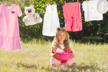 Cute little girl laundring