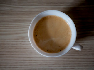 Cup of coffee on wooden background