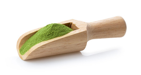matcha green tea powder in wood scoop on white