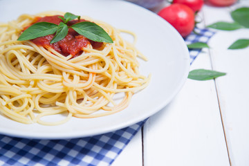 Spaghetti pasta with and tomato sauce on wood background