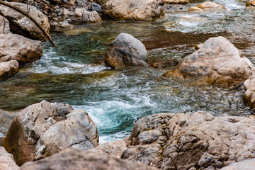 The mountain river Roudoule in the low French Alps: the turquoise stream running through the rocks