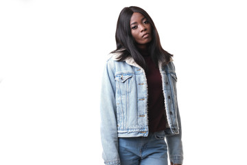 Fashion shoot of afro-american model wearing jeans jacket and burgundy golf silted on white background.