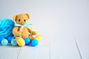 Birthday boy background with teddy bear , blue small balls and honeycomb ball , space for text