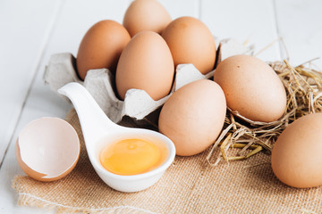 Eggs chicken on white wood background
