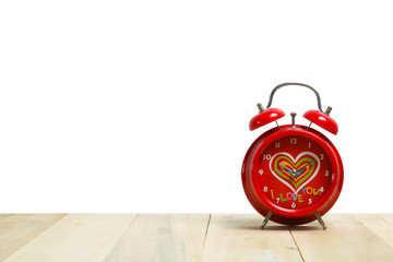 Red alarm clock on old wood with white background