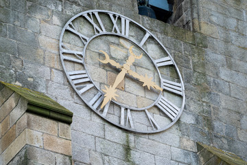 Detail view of the analog clock with roman numerals on the Porto Cathedral in Porto, Portugal