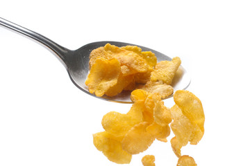 Cornflakes on spoon  isolated on white background