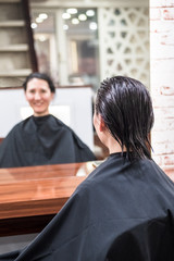 Brunette woman in hairdressing beauty salon waiting for haircut