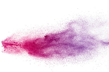 Freeze motion of purple color powder exploding on white background.