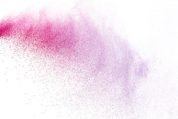 Freeze motion of purple color powder exploding on white background.