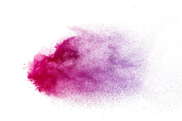 Freeze motion of purple color powder exploding on white background.