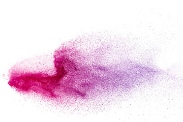Freeze motion of purple color powder exploding on white background.