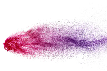 Freeze motion of purple color powder exploding on white background.