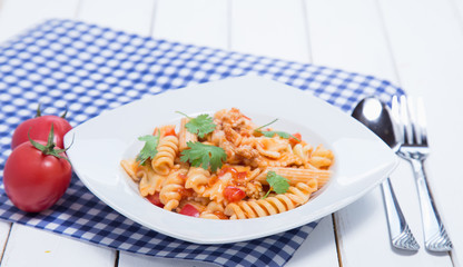 Spaghetti pasta with and tomato sauce on wood background