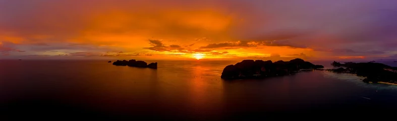 Zelfklevend Fotobehang Aerial view of Phi Phi, Maya beach with blue turquoise seawater, mountain hills, and tropical green forest trees at sunset with Andaman sea  island in summer, Thailand in travel trip. Nature. Panorama © netsay